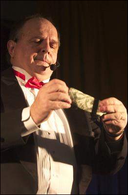 Dennis Michael performs a magic trick for students at Assumption School in Atco