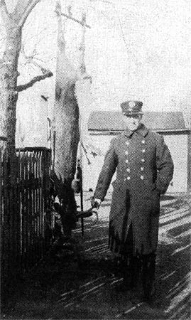 James J. Monahan in Fire Department uniform with a deer he shot while hunting with his father-in-law and brother-in-law