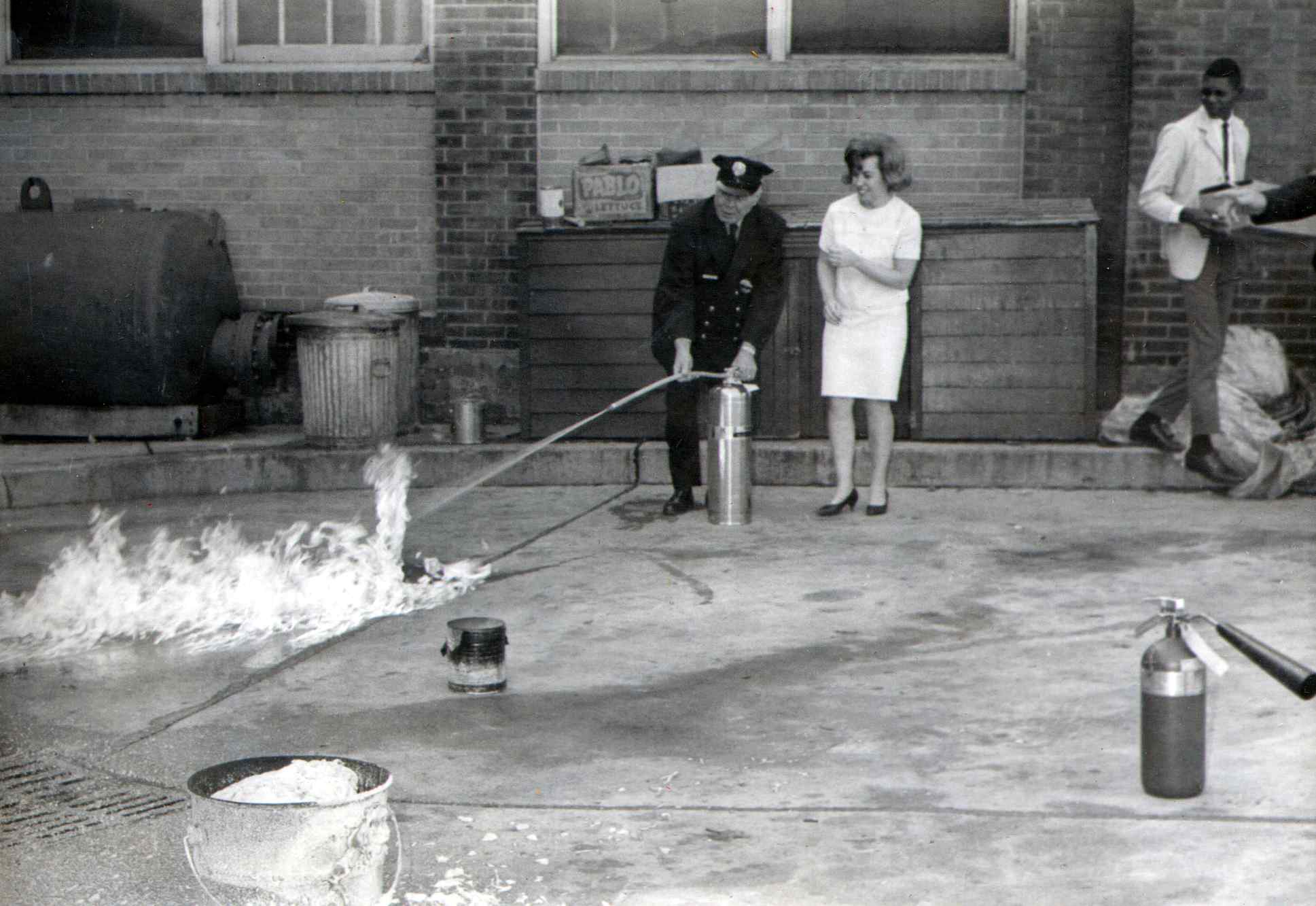 John Gaffney Sr. demonstrating fire extinguisher use at Cooper Hospital, October 1966