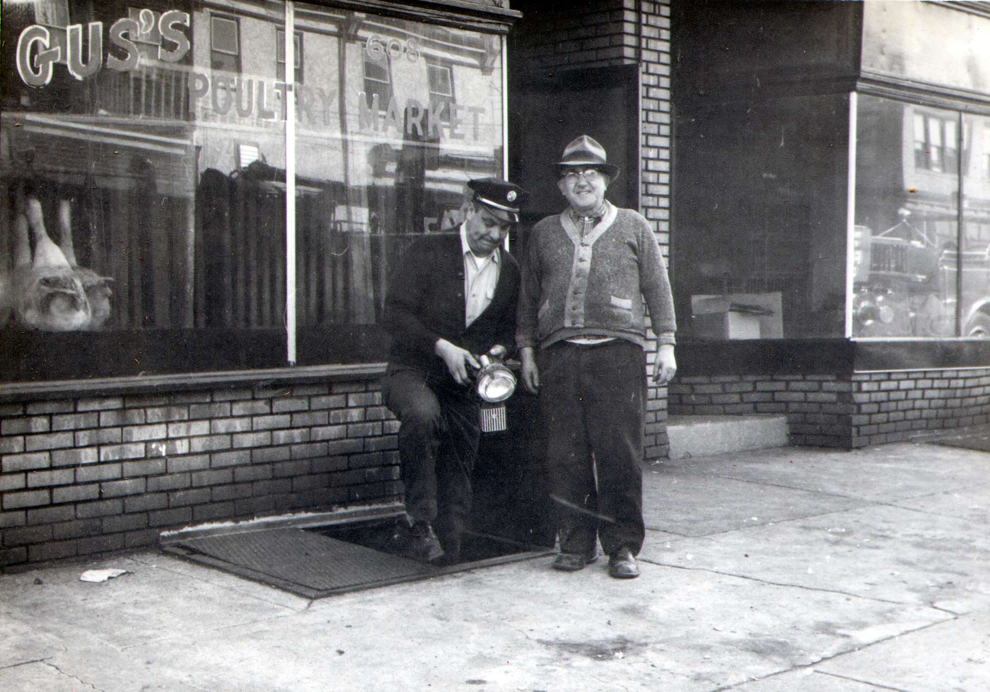 Captain Joseph D. DiMattia completing fire inspection at Gus's Poultry Market, 608 Kaighn Avenue, May 1966
