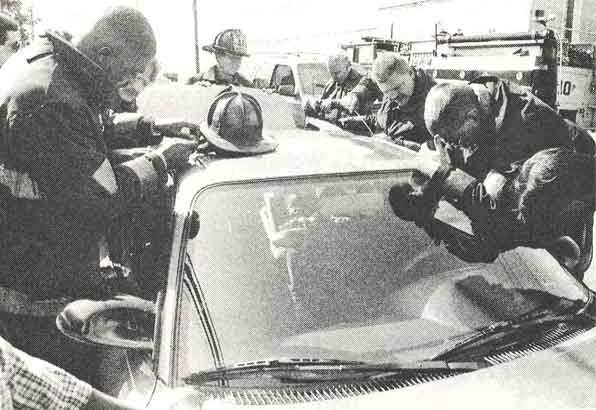 Members of Camden NJ Rescue 1 work to free a one year old baby locked in a parked car, Fairview Street, 1997