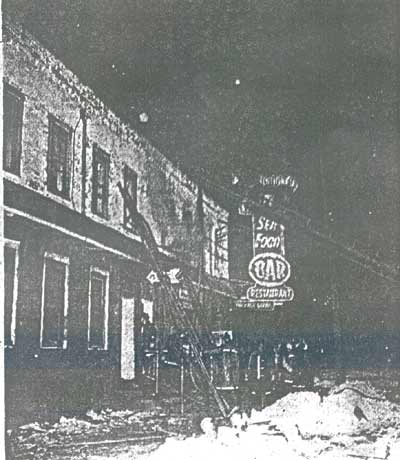 Firemen climb ladder to the roof and second floor of the blaze at Ray's Tavern, 5th and Mickle Streets, February 1967