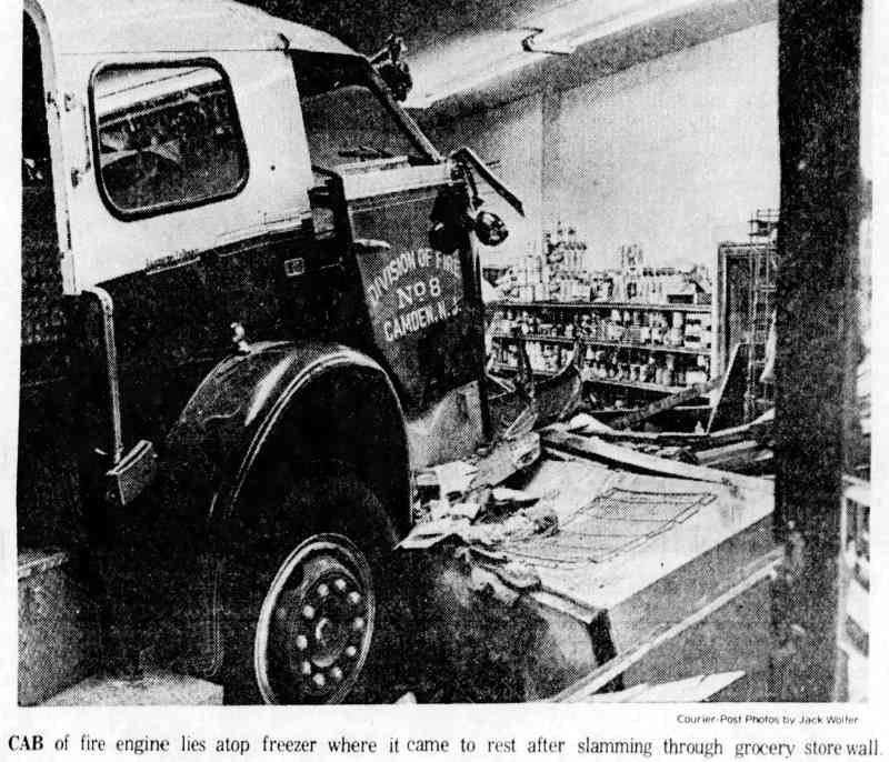 Cab of fire engine lies atop freezer after slamming through grocery store wall