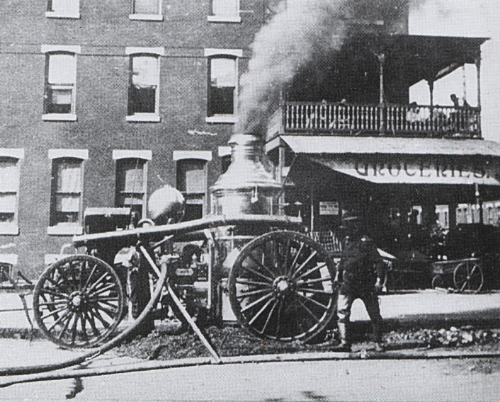 Engineer Bob Steer tends Engine 4 while supplying water at the Camden Storage Fire, May 6, 1904