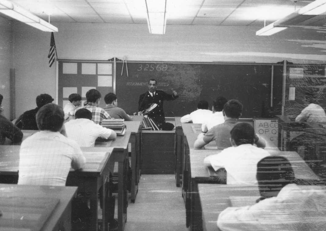 Captain Theodore Primas teaching fire safety in a Camden classroom, March 25, 1968