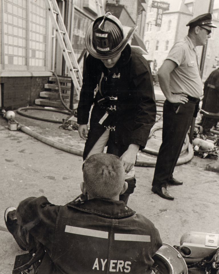 Canteen Corpsman Peter Meyer serves refreshments to Captain William Ayers of Ladder Company 1 following a Third Alarm fire at Haddon Avenue and Federal Street, August 14, 1969, photograph by Bob Bartosz