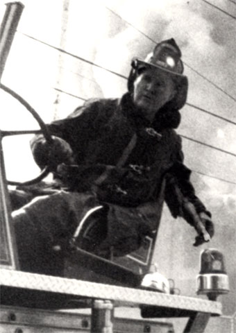 Firefighter William Hopkins at the tiller of Ladder Company 1, October 9, 1973, fire at Liberty Public School