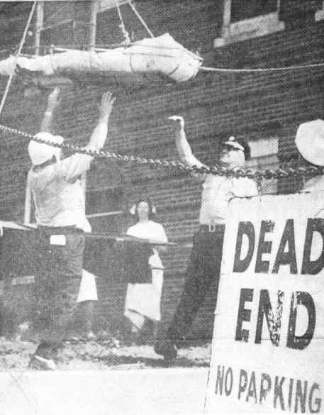 Firefighters lower patient in stokes basket during West Jersey Hospital fire drill, 1965