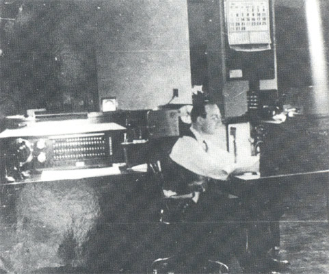 Fire Alarm Dispatcher Michael A. Mignona working the PBX Fire Board on the eighth floor of City Hall, circa 1940