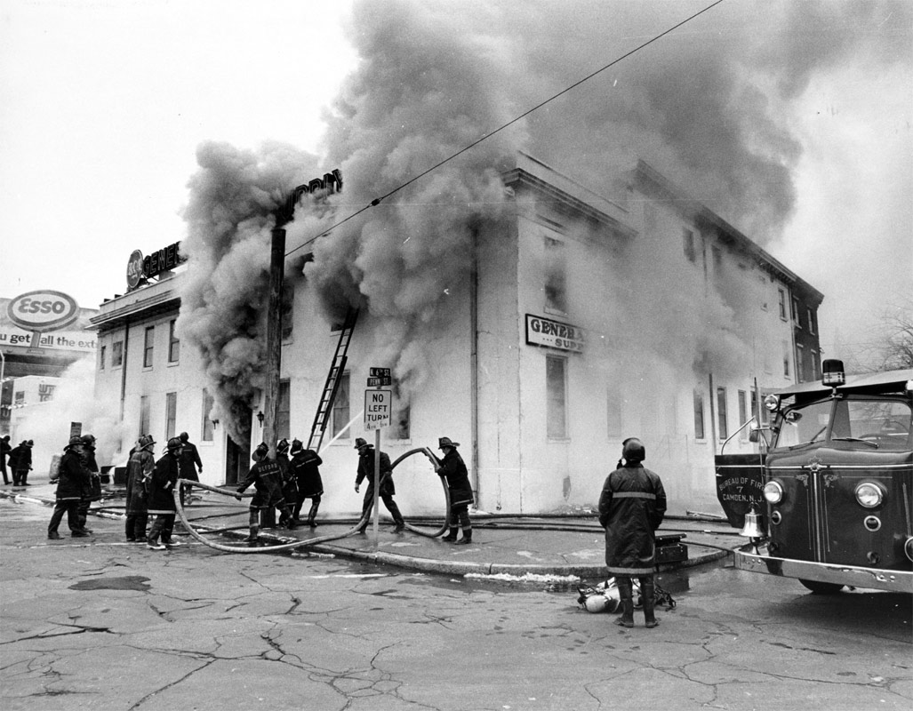 Manpower of two Engine Companies get big line into service at Fourth Alarm, North 6th and Penn Streets, March 30, 1970