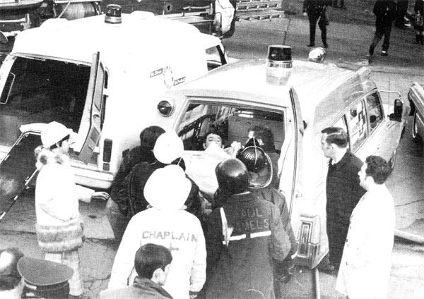 Captain Maycott carried to waiting ambulance after collapse rescue, continued