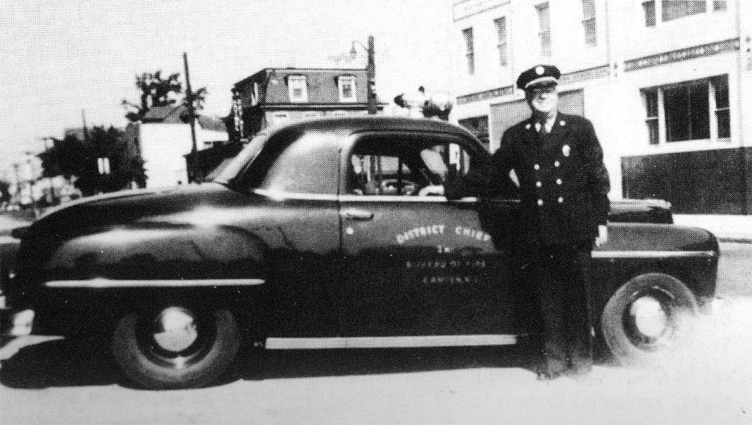 District Chief Robert Wonsetler in front of 2nd Battalion headquarters, 27th and Federal Street, 1950s