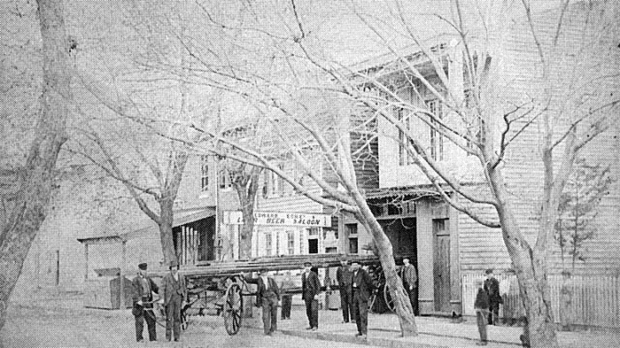 The United States Fire Company No. 5 with hand drawn ladder and members in front of quarters at 239 Pine Street South Camden, circa 1860
