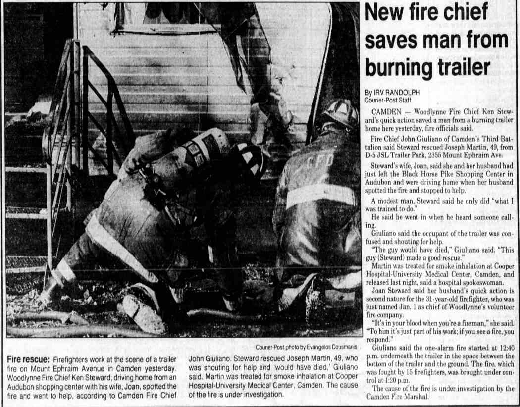 Firefighters at trailer fire on Mount Ephraim Avenue, Camden — Woodlynne Fire Chief Ken Steward rescues Joseph Martin, January 15, 1991