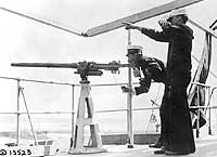 USS DeKalb officer firing a signal gun, 18 May 1918