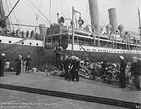 Sailors on pier with items from Prinz Eitel Friedrich, 20 April 1917