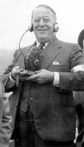 James A. Howell wearing headphones and holding a radio microphone at Central Airport, October 29, 1931