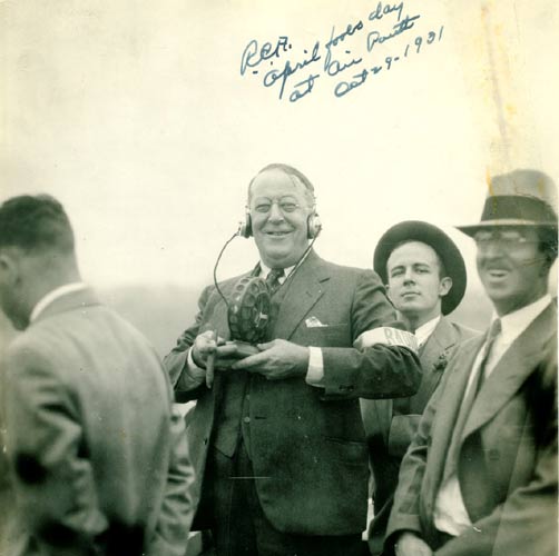 James A. Howell with headphones and radio equipment surrounded by people at Central Airport, October 29, 1931