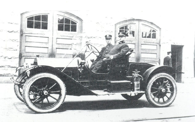 Martin Carrigan with Chief John A. Stockton in 1913 Cadillac at Fire Headquarters