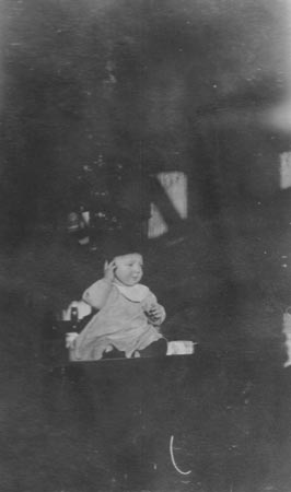 Grandson Gus Gondolf Jr., sitting on the bar of the Temple Saloon