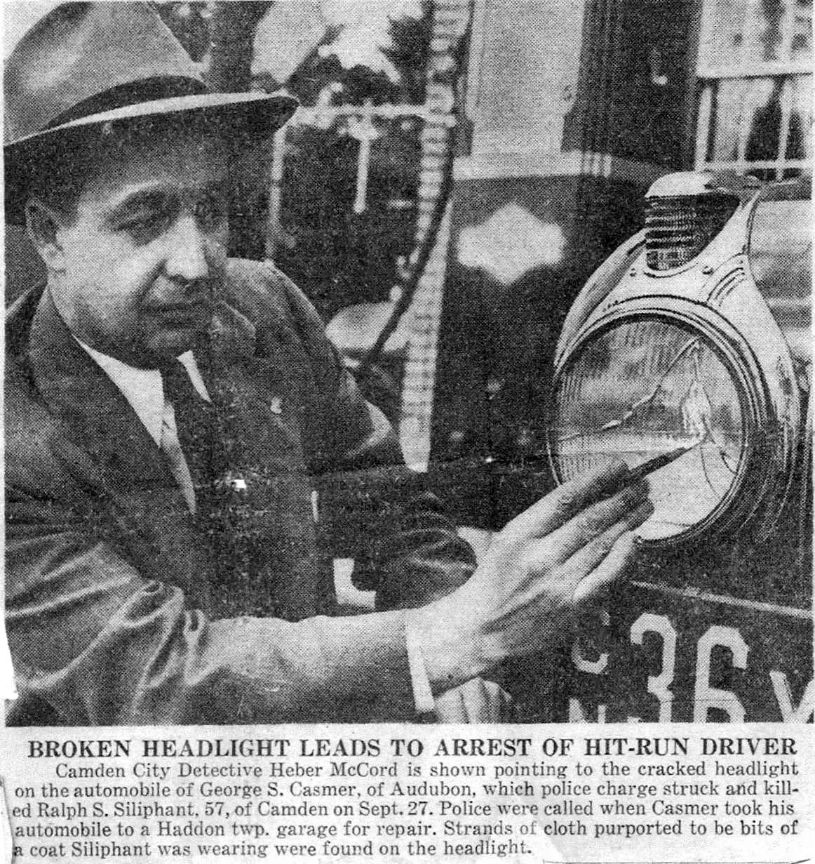 Detective Heber McCord points to the cracked headlight on the automobile of George S. Casmer, October 1942