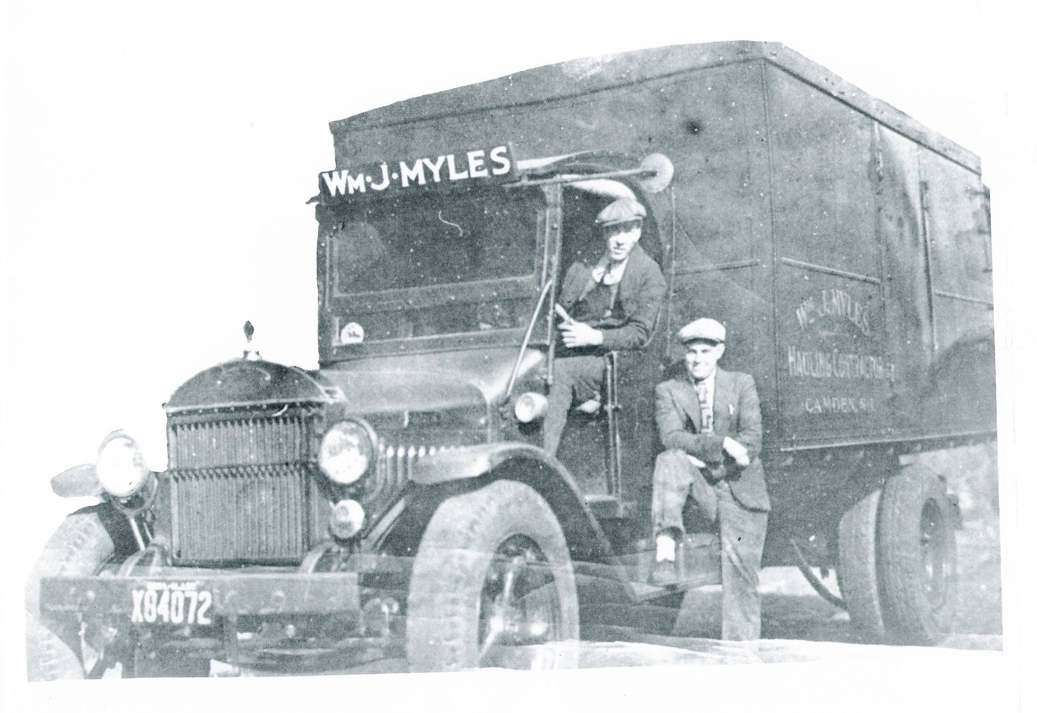 The driver is unknown; the man with foot on running board is William J. Myles