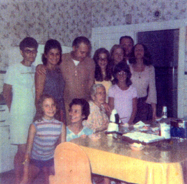 Nasuti children and grandchildren in the kitchen at 25 North 25th Street; Antoinette Nasuti seated at the table