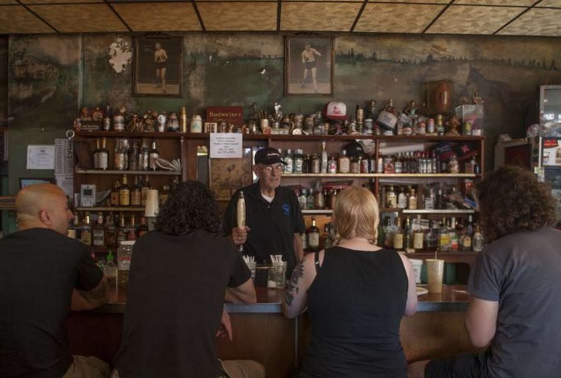 Bob Lucas stands behind his bar at Donkey's Place
