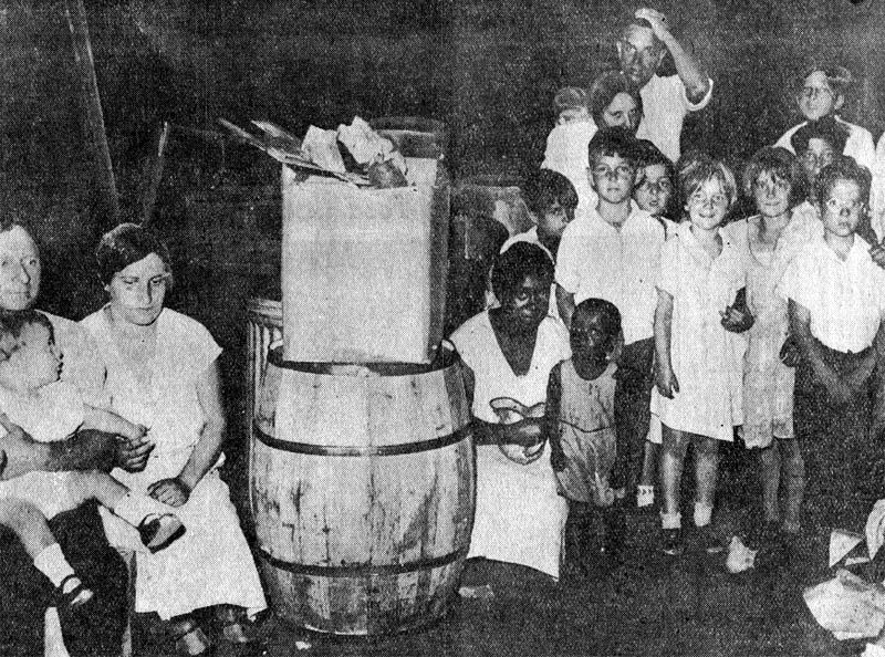 Receptacles containing refuse and garbage from the county jail in the old courthouse building basement, where needy await clothing and shoes, June 24, 1933