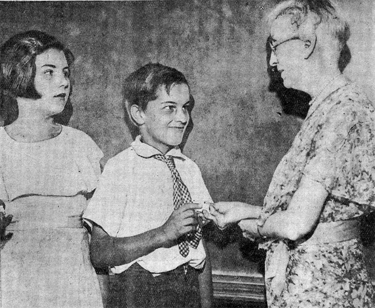 Miss Minerva C. Stackhouse awarding rings to honor students Dorothy Nicholson and Karl Koehler at H.H. Davis School