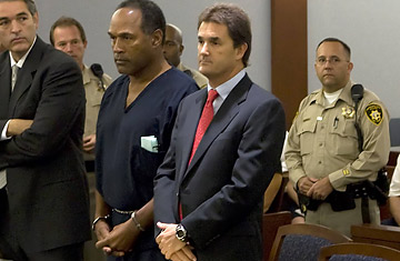 OJ Simpson and his attorney Yale Galanter listen as the charges against the former actor and football player are read in a Las Vegas Court
