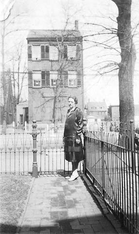 View from the front step of 708 Market Street, with Elizabeth Lizzie Boyer Koehler at front gate. The building across the street is 709 Market Street, which at the time was the Friend's School.