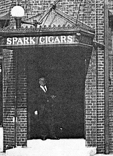 Frank J. Hartmann Sr. standing in the doorway of his cigar shop, 1920s