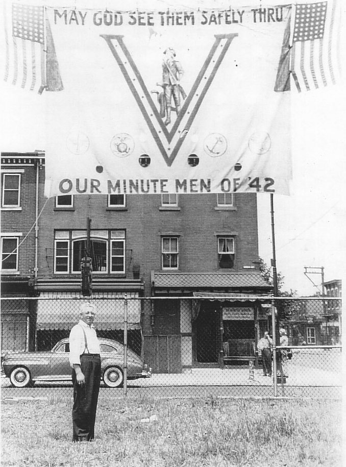 Herman Levin standing in front of his store at the corner of Kaighn Avenue and South 3rd Street, 1942