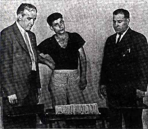 Anthony Carrozza between Detectives Thomas Murphy and August Fortune