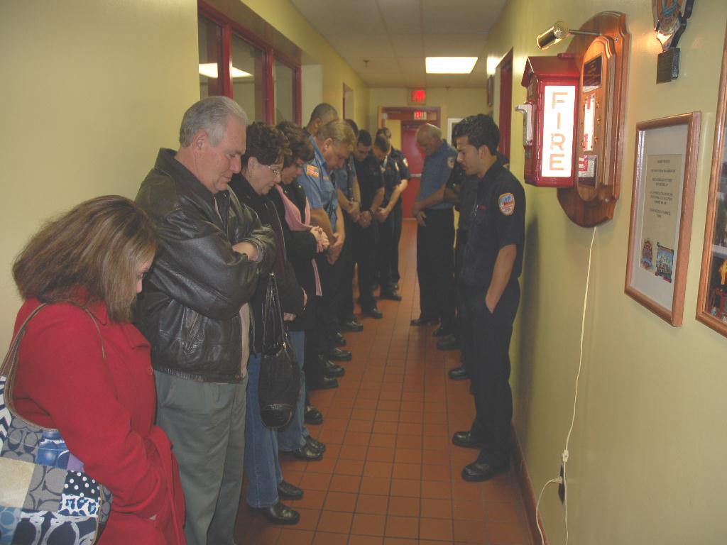 Engine Company 8 fire fighter Arnaldo Guzman offering a prayer in remembrance of fire fighter Ernie Tartaglia, December 9, 2007
