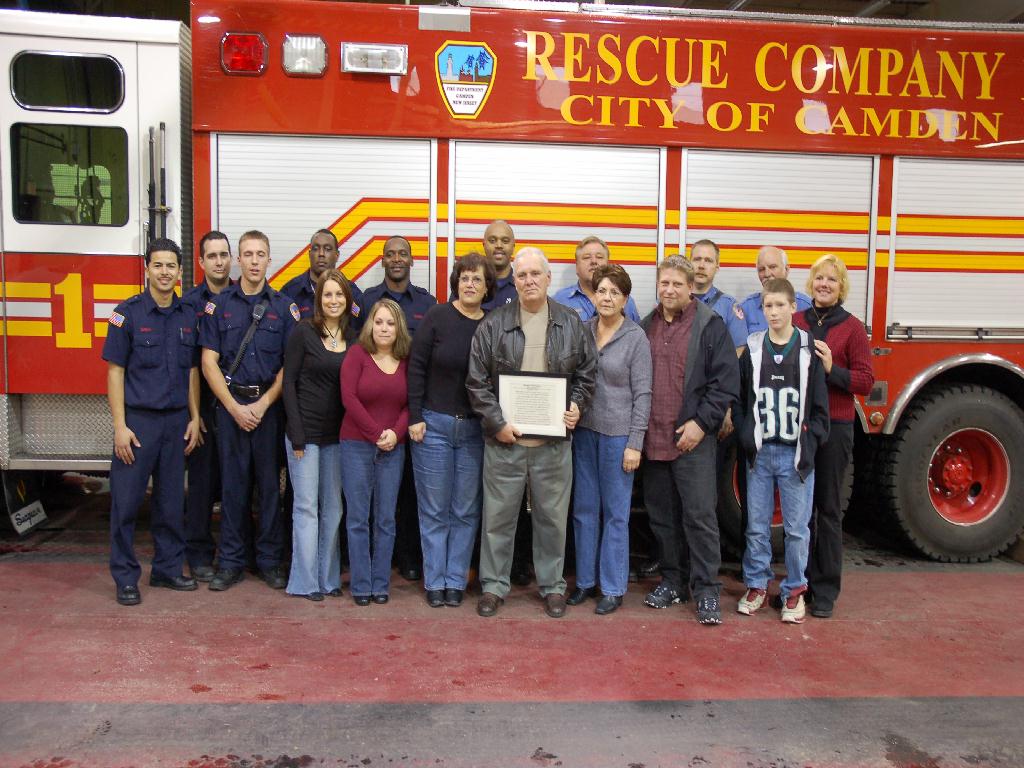Group photo of fire fighters and Tartaglia family, December 9, 2007