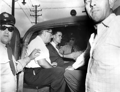 Immediately after Howard Unruh surrendered, River Road at 32d street becomes crowded with police and curiosity seekers. Minutes later Unruh sits perfectly calm in police wagon. Camden Courier-Post - September 7, 1974