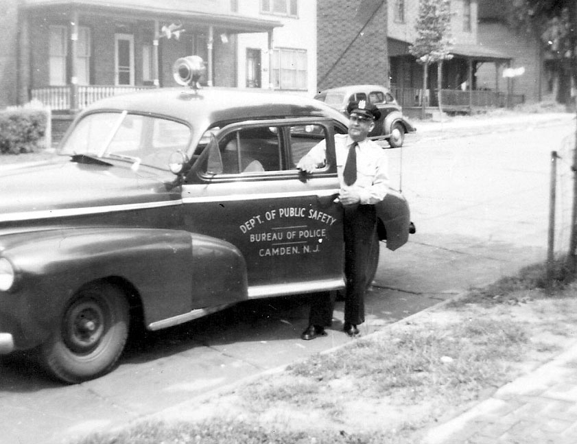 Harold Vecander standing next to a Camden Bureau of Police patrol car on North 26th Street near Wayne Avenue