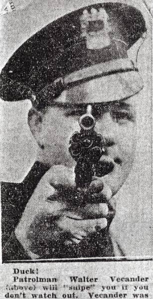 Portrait of Walter Vecander in police uniform aiming revolver