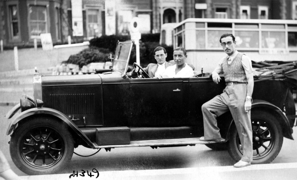 Harry Kahn, Joe Loss, and friend in Bournemouth, August 1933 — Joe Loss driving, Harry Kahn standing on running board